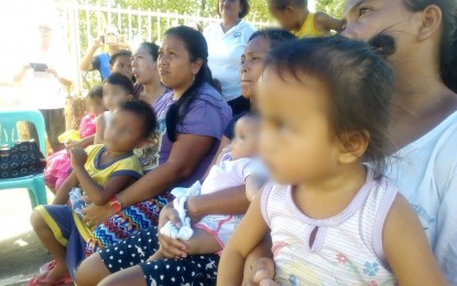 <p>Mothers of malnourished children in Carigara, Leyte await for their toddlers' turn to be weighed by local health workers. <em>(photo by Sarwell Meniano)</em></p>